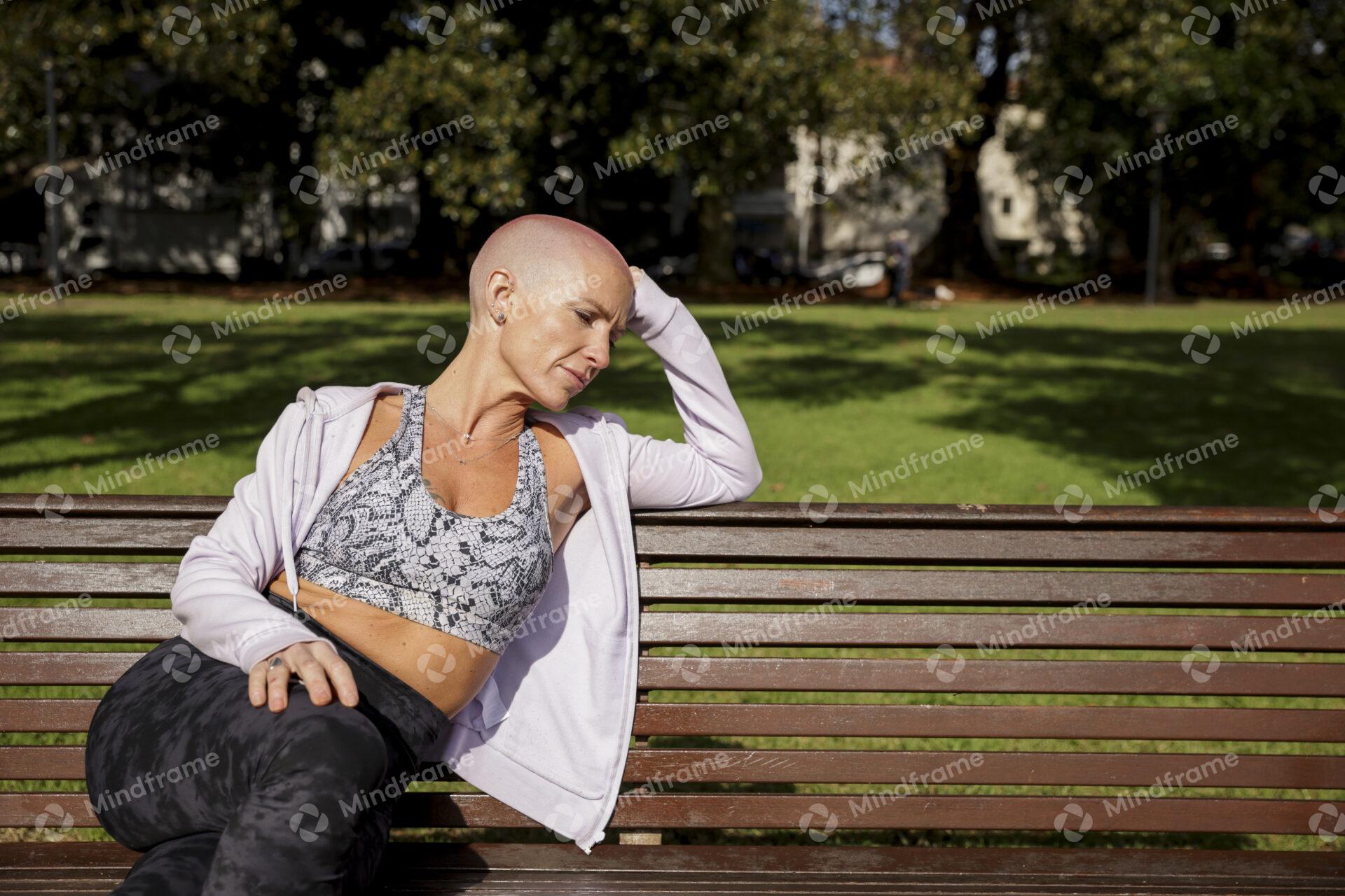 One person thinking, sitting on a bench at a park