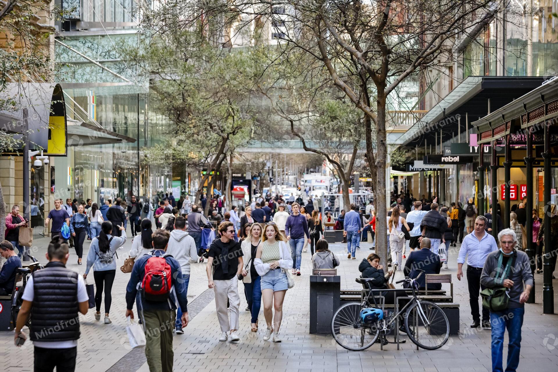 People outside walking through a mall in the city